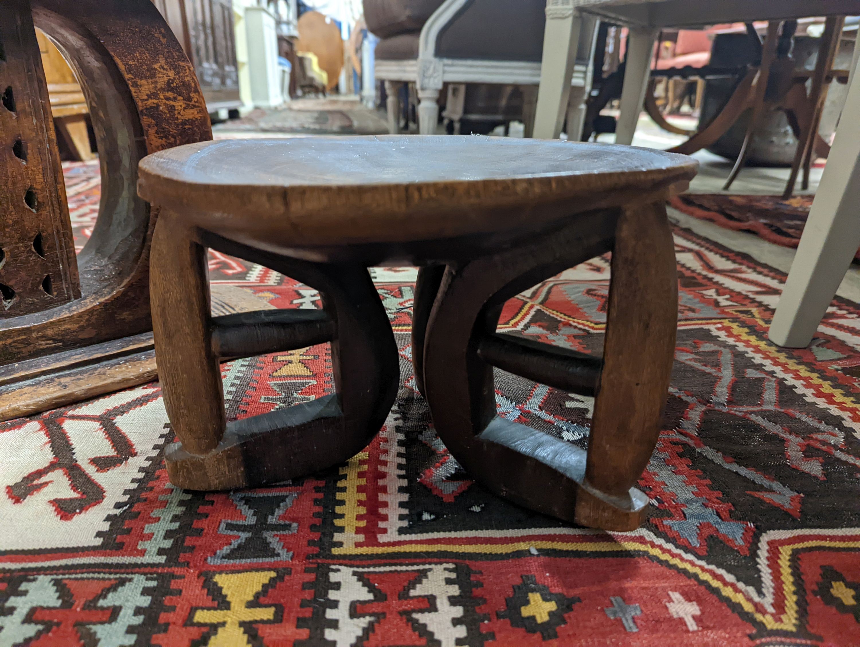 Two African carved hardwood stools, larger length 43cm, depth 19cm, height 37cm